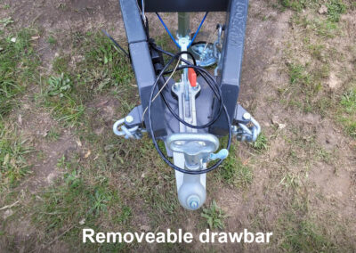 Detail of a caravan's removable drawbar connection point, showcasing the heavy-duty coupling and safety chains.