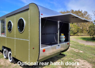Caravan rear with one large optional hatch door open, showcasing the customizable access for storage or commercial use.